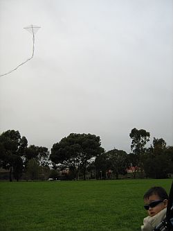 Kite Blog - Aren flying a clear plastic 1-Skewer Diamond kite from his pram.