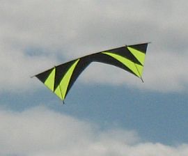 A black and flouro green quad kite in flight.