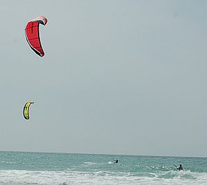 2 kite surfers in action at Haifa beach, in Israel.