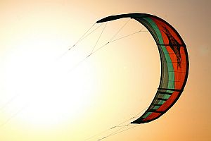 Great into-sun shot of a surfing kite, taken near sundown.