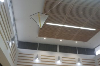 The MBK Indoor Diamond kite flying in a spacious indoor area.