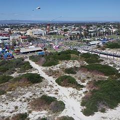 The rides, stalls and other attractions near the entrance to the jetty.