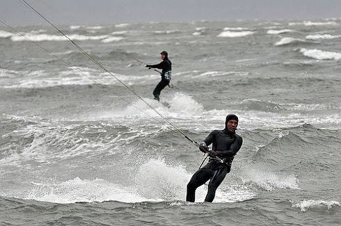 Two kite surfers in action