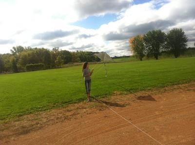 Packing up after flying first kite - sister Grace pulling