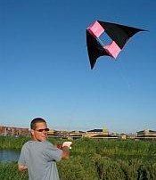 A delta conyne box kite being launched.
